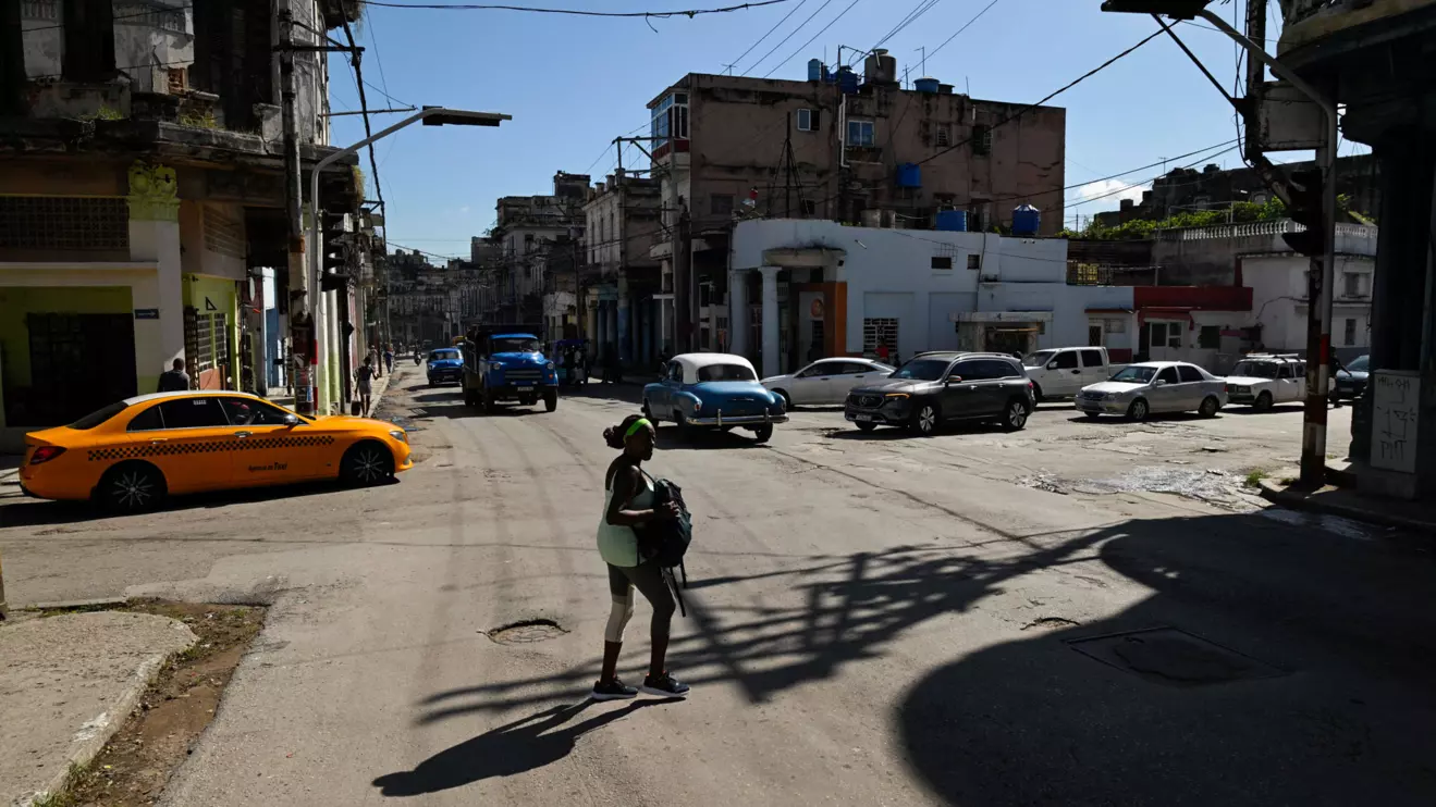 A woman crosses a street during a national power grid collapse, for the fourth time in less than a year, which caused a nationwide blackout, in Havana, Cuba, September 10, 2025. Reuters/Norlys Perez