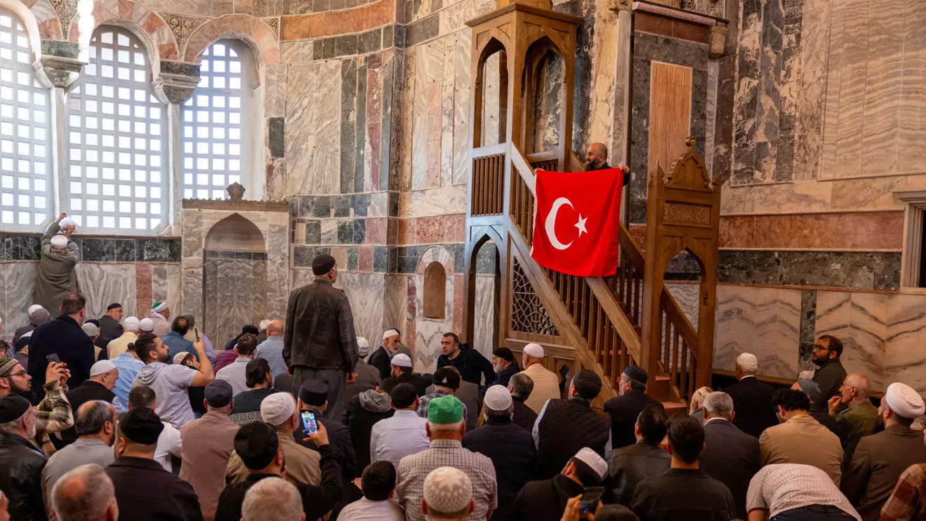 A worshipper holds Turkey's national flag during an afternoon prayer at Chora Museum or Kariye Mosque, one of the city's most celebrated Byzantine churches which was reconverted into a mosque in 2020 and re-opened its doors to visitors and worshippers after a four year-long restoration process, in Istanbul, May 6, 2024. Reuters/Umit Bektas