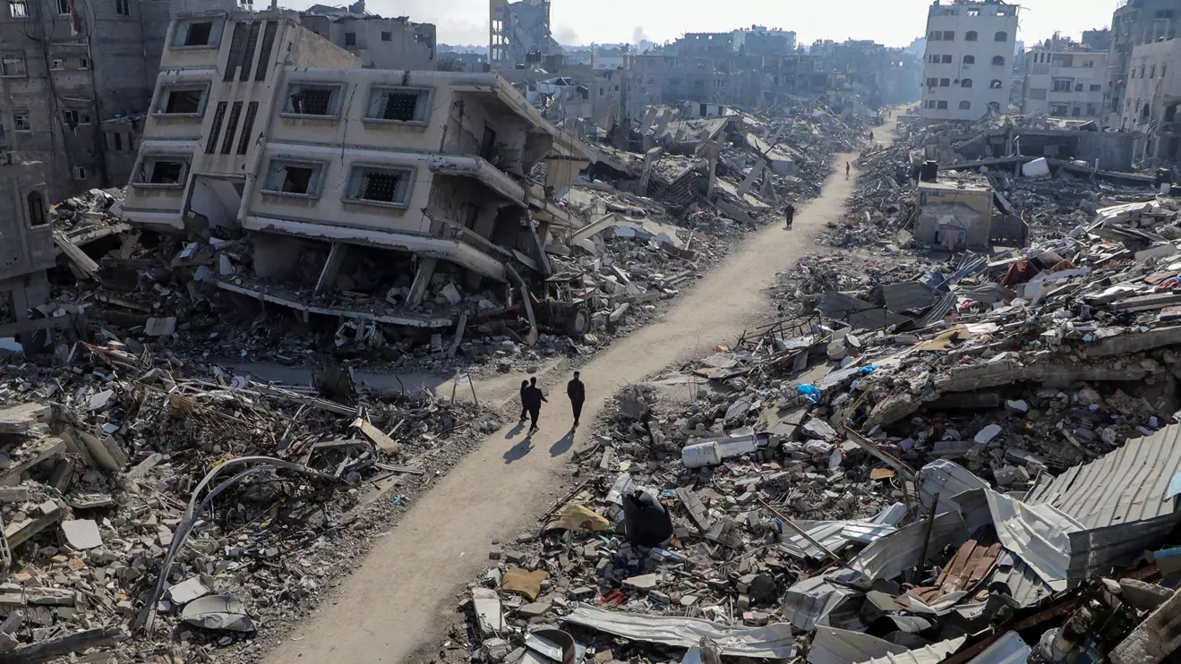 Palestinians walk past destroyed houses, amid the ongoing conflict between Israel and Hamas, in Jabalia refugee camp, in the northern Gaza Strip February 22, 2024. Reuters/Mahmoud Issa