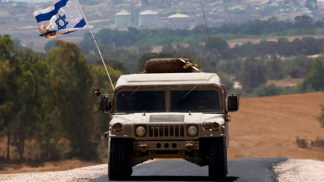 A military vehicle maneuvers near the Israel-Gaza border, amid the Israel-Hamas conflict, as seen from Israel, June 20, 2024. Reuters/Amir Cohen