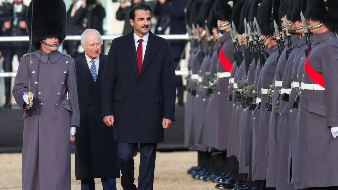 Britain's King Charles, walks with Qatari Emir Sheikh Tamim bin Hamad al-Thani at a ceremonial welcome, during the state visit of Qatari Emir and his wife Sheikha Jawaher bint Hamad bin Suhaim Al-Thani, at Horse Guards Parade, in London, Britain, December 3, 2024. Reuters/Toby Melville
