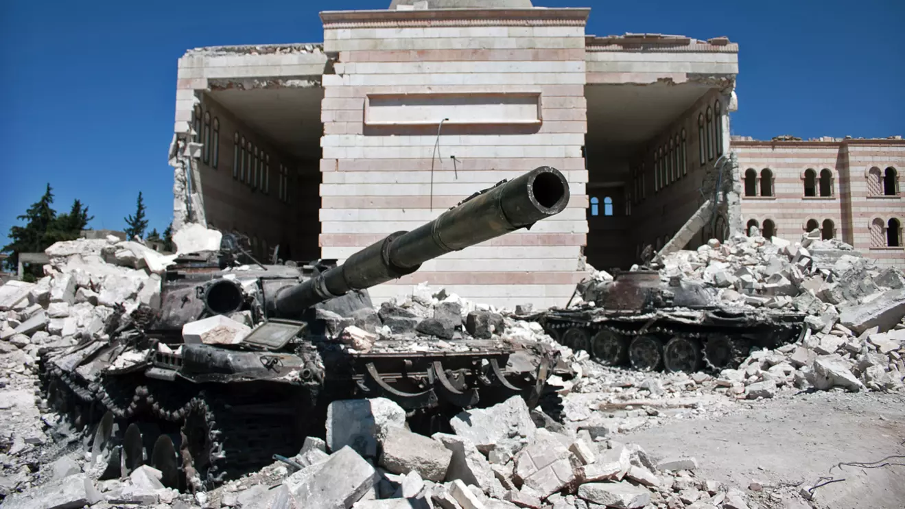 Azaz, Syria A destroyed tank in front of a similarly ruined mosque © Mena Today 