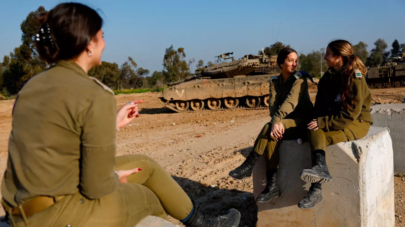 Israeli soldiers sit during a break near the Israel-Gaza border, amid the ongoing conflict between Israel and the Palestinian Islamist group Hamas, in Israel, February 28, 2024. Reuters/Amir Cohen 