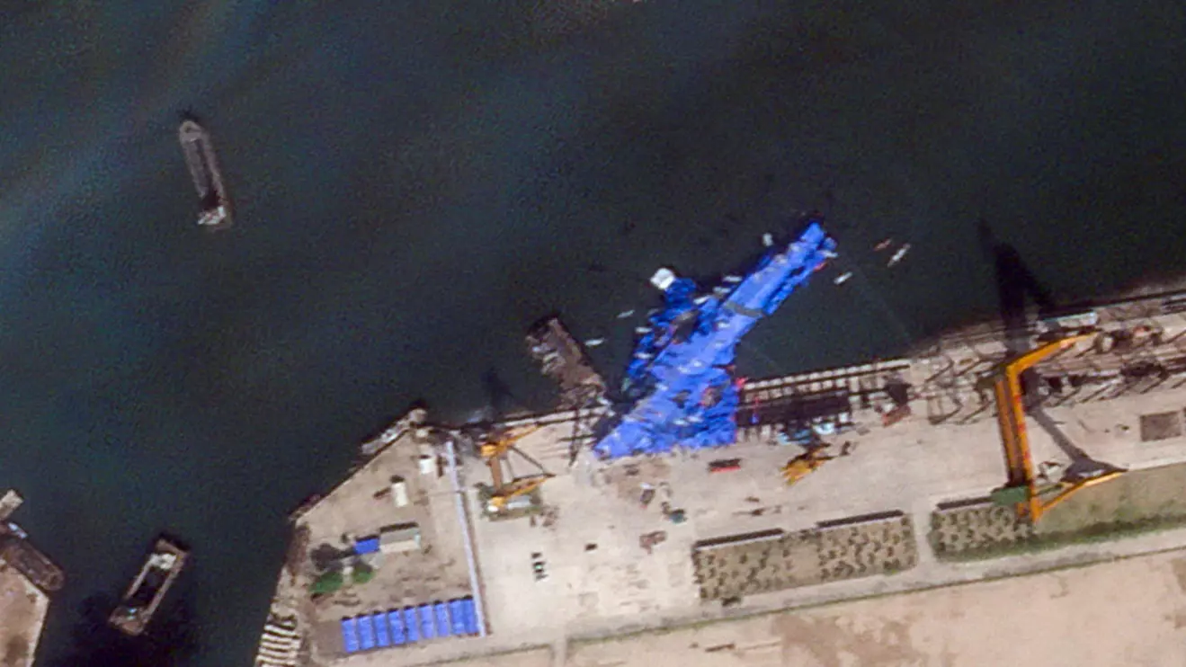A satellite image shows a North Korean warship covered with a blue tarp after an accident that occurred during its launch at the shipyard in Chongjin, North Korea, May 23, 2025. 2025 Planet Labs PBC/Handout via Reuters