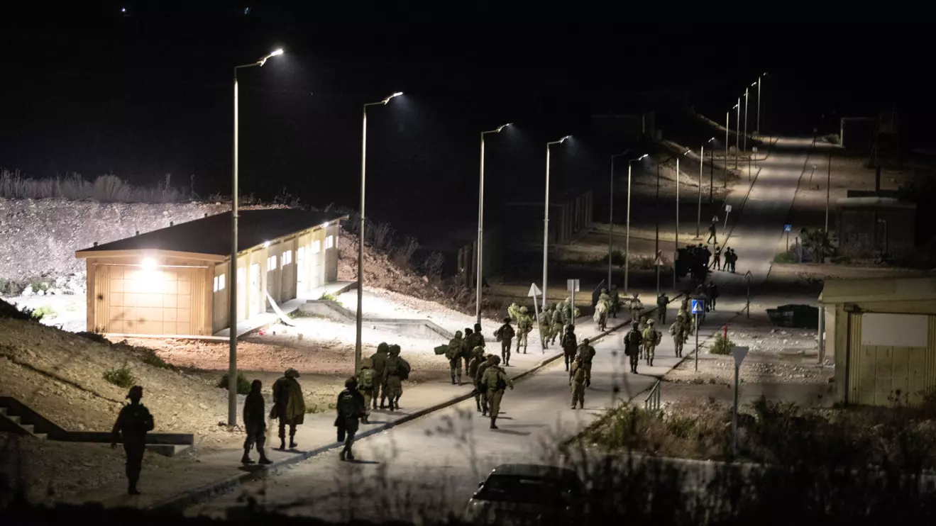 Israeli soldiers walk near the scene where a drone from Lebanon attacked Israel, amid cross-border hostilities between Hezbollah and Israel, in Binyamina Israel, October 13, 2024. Lebanon's Hezbollah claimed responsibility for the attack. Reuters/Itay Cohen