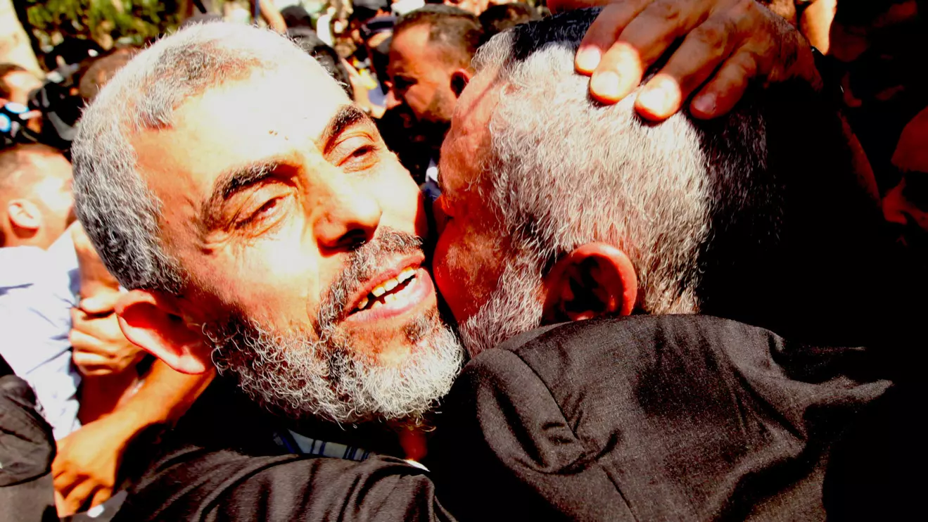 Freed Hamas top security strategist Yehya Al-Sinwar is hugged by senior Hamas leader Ismail Haniyeh (R) upon his arrival at the Rafah crossing with Egypt in the southern Gaza Strip October 18, 2011.Reuters/Mohammed Salem