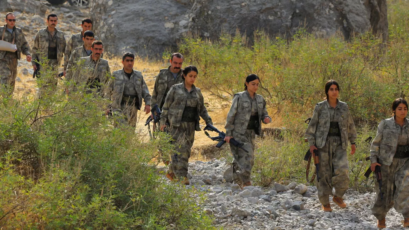 Fighters with the Kurdistan Workers' Party (PKK) walk to a disarmament ceremony marking a significant step toward ending the decades-long conflict between Turkey and the outlawed group, in the Qandil mountains, Iraq October 26, 2025. Reuters/Thaier Al-Sudani