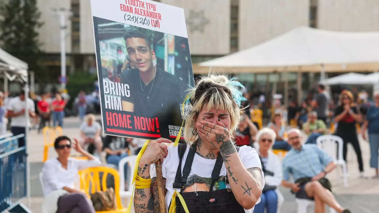 A person holds a sign with a picture of the Israeli-American hostage, Edan Alexander, who was kidnapped during the deadly October 7 attack, on the day Edan Alexander is expected to be released from captivity by Hamas in Gaza, in Tel Aviv, Israel May 12, 2025. Reuters/Ronen Zvulun
