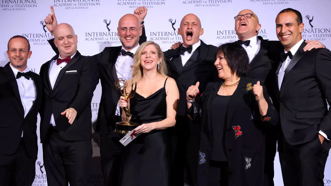 Creator and Executive Producer Dana Eden and Executive Producer Shula Spiegel pose backstage with cast and crew members after winning an Emmy for "Tehran" in the category Drama at the 49th International Emmy Awards in New York City, New York, U.S., November 22, 2021. Reuters/Caitlin Ochs