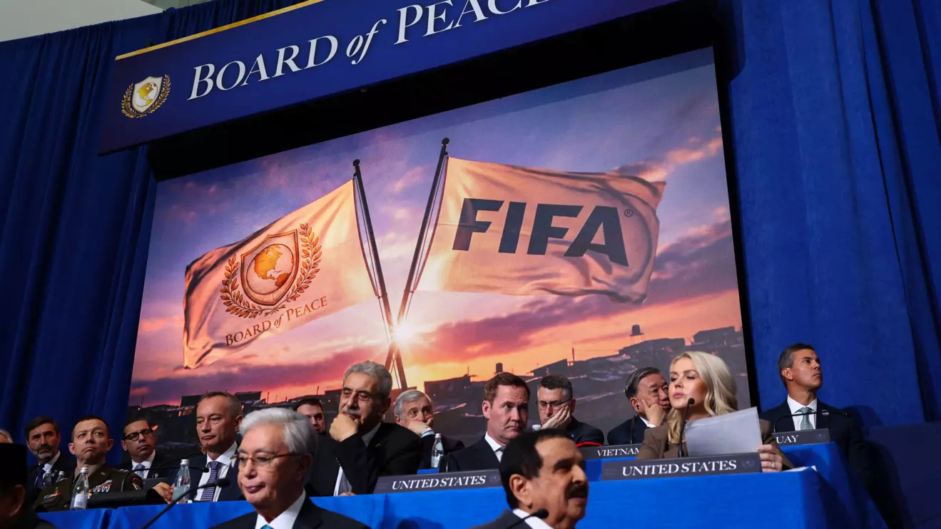 A screen displays an image of FIFA and Board of Peace flags, during the inaugural Board of Peace meeting at the U.S. Institute of Peace in Washington, D.C., U.S., February 19, 2026. Reuters/Kevin Lamarque