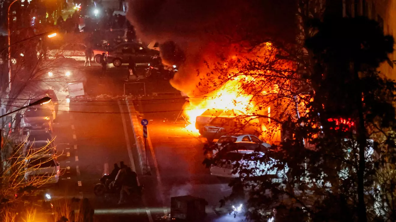 Cars burn in a street during a protest over the collapse of the currency's value, in Tehran, Iran, January 8, 2026, WANA (West Asia News Agency) via Reuters