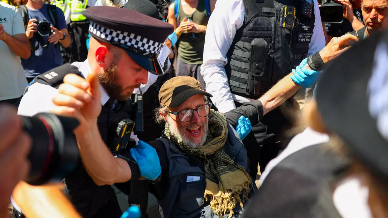 Police officers carry a protester during a demonstration calling for the de-proscription of the Palestine Action group, in Parliament Square, in London, Britain, July 12, 2025. Reuters/Isabel Infantes