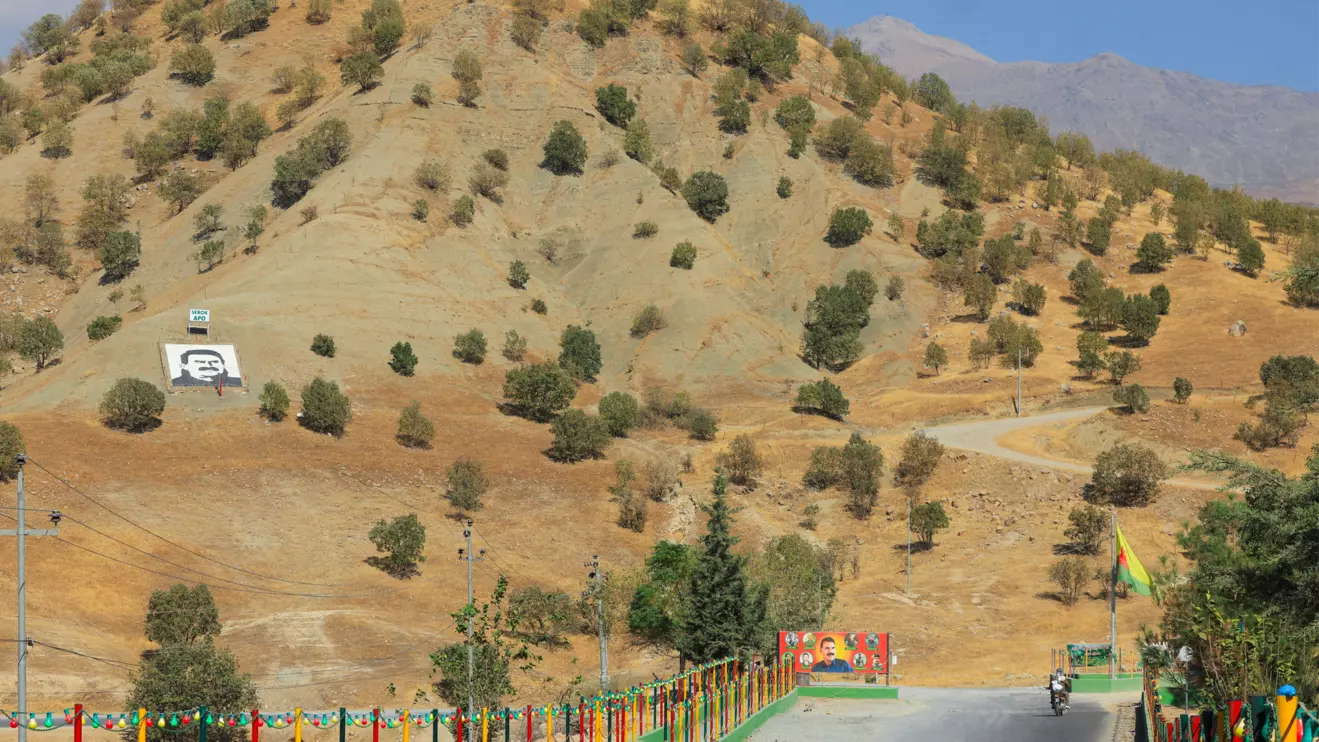 A portrait of jailed Kurdistan Workers Party (PKK) leader Abdullah Ocalan and a sign with the words "Serok Apo," are displayed on a hillside in the Qandil mountains, Iraq, October 26, 2025. Reuters/Thaier Al-Sudani