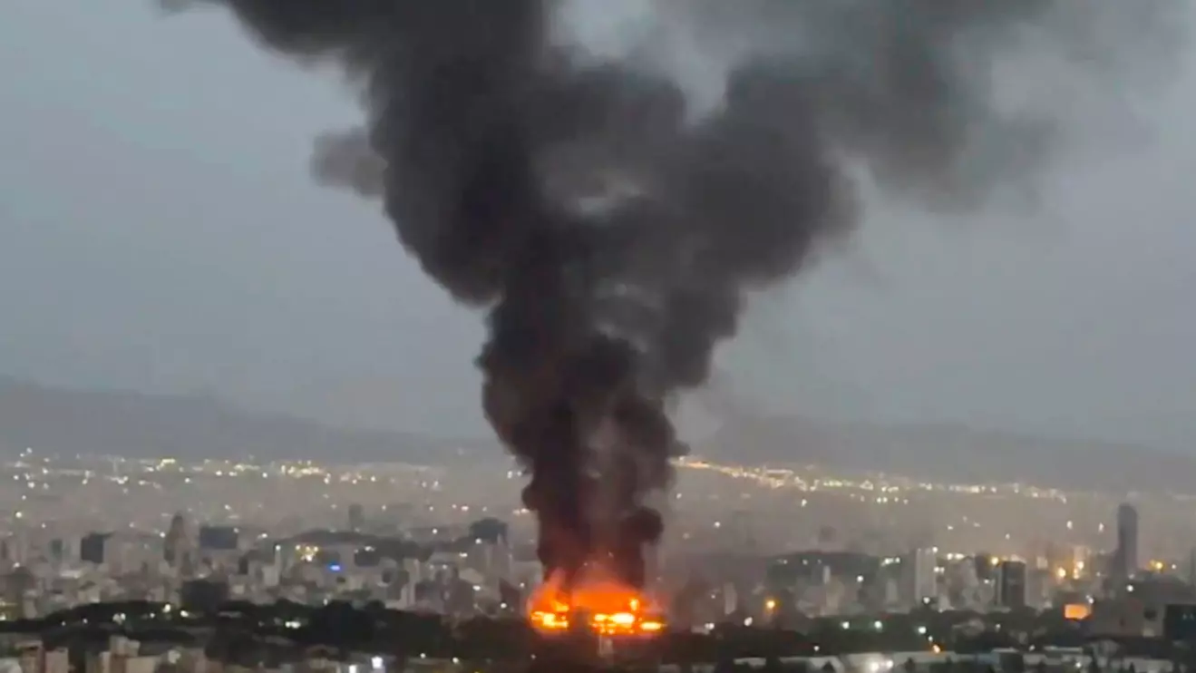 Smoke rises from a fire, as the Israel-Iran air war continues, in Tehran, Iran, in this still image obtained from social media video released June 17, 2025. Social Media/via Reuters