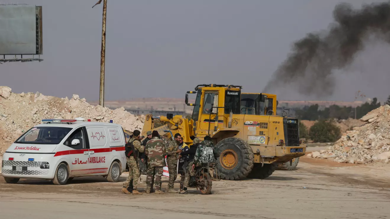 Members of the Syrian army gather at an evacuation site, after the Syrian Democratic Forces (SDF) made an agreement with the Syrian government to depart and evacuate to northeastern Syria after days of fighting with the Syrian army, in Aleppo, Syria, January 9, 2026. Reuters/Khalil Ashawi