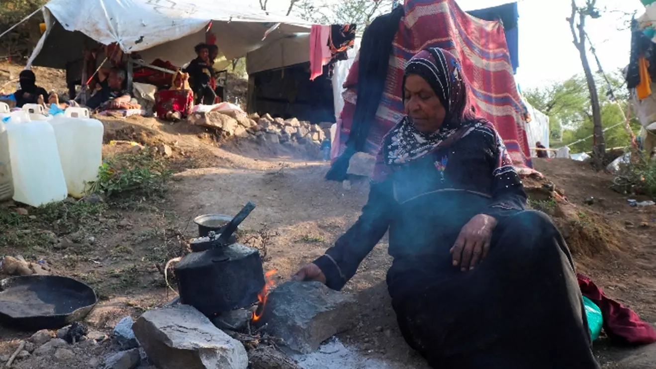 Aisha Muhammad cooks at a makeshift camp for internally displaced people after fleeing her home during clashes between Iran-aligned Houthi fighters and Saudi-backed Yemeni government forces, in Taiz province, Yemen September 13, 2026. Reuters