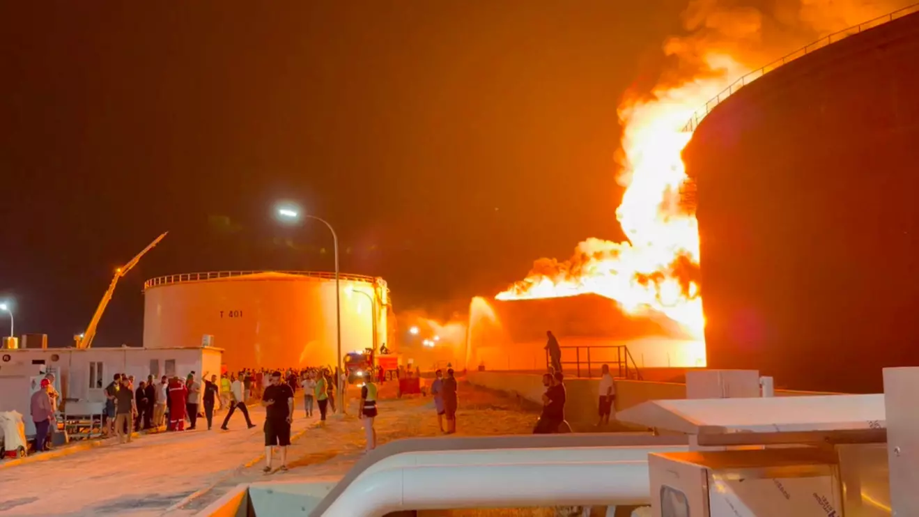 A fire in a storage tank burns as firefighters work to control the blaze, at an oil refinery in Zawiya, Libya August 10, 2026, in this still image from video obtained by Reuters