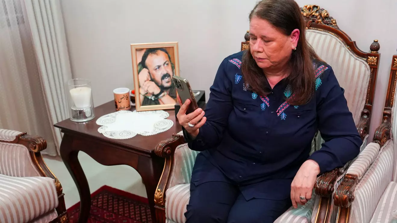 Fadwa Barghouti watches a video of the visit of the Israeli National Security Minister Itamar Ben-Gvir to her husband Marwan Barghouti, in Ramallah, West Bank, August 15,2025. Reuters/Ali Sawafta