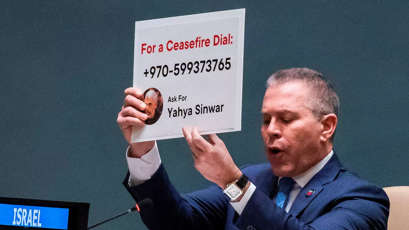 Israeli ambassador to the UN Gilad Erdan shows a poster with the image of a Hamas leader on it as he speaks to delegates during the United Nations General Assembly expected to vote on ceasefire resolution, amid the ongoing conflict between Israel and the Palestinian Islamist group Hamas, in New York City, U.S., December 12, 2023. Reuters/Eduardo Munoz