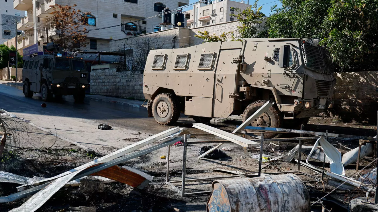 Israeli military vehicles pass by during a raid, amid the ongoing conflict between Israel and the Palestinian Islamist group Hamas, in Jenin, in the Israeli-occupied West Bank December 14, 2023. Reuters/Raneen Sawafta