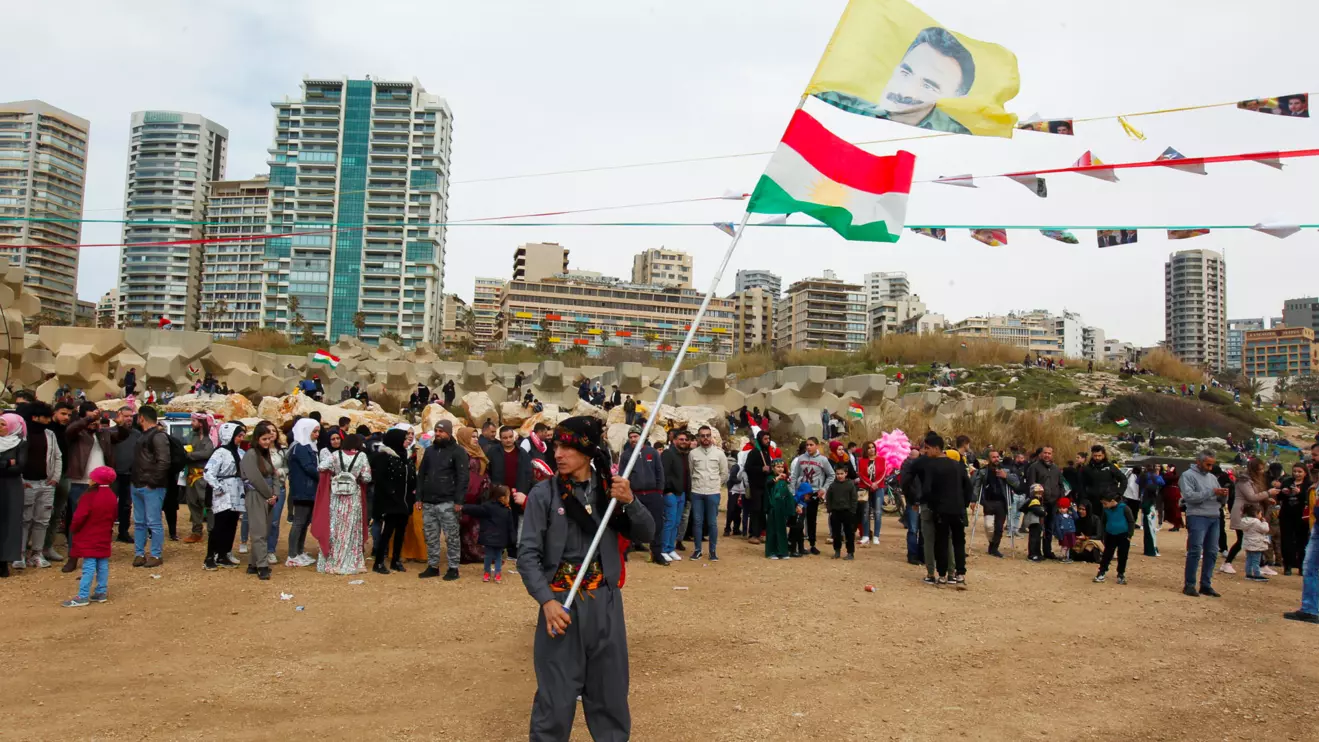 A Kurdish man carries a flag with a portrait of jailed Kurdistan Workers Party (PKK) leader Abdullah Ocalan during Nowruz festival celebrations, in Beirut, Lebanon March 20, 2022. Reuters/Aziz Taher