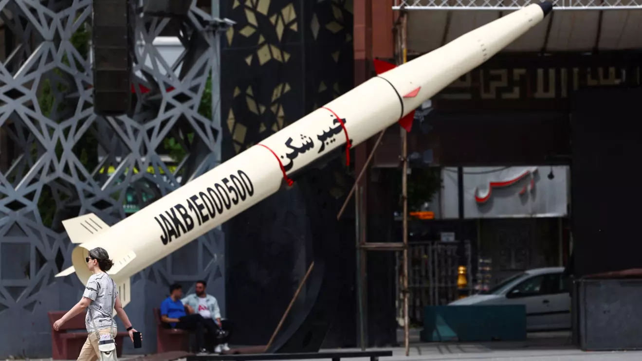 A woman walks next to a symbolic mock-up of an Iranian missile, amid a ceasefire between U.S. and Iran, in Tehran, Iran, April 27, 2026. Majid Asgaripour/WANA (West Asia News Agency) via Reuters