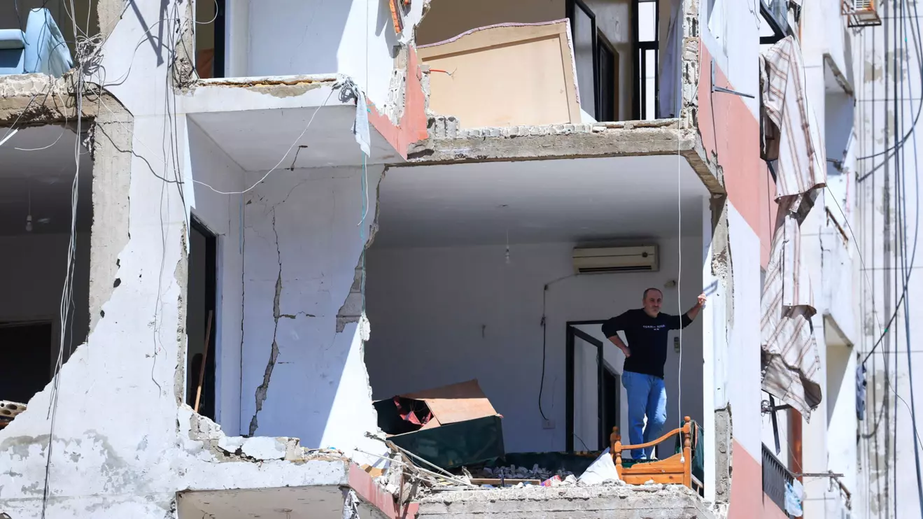 A man stands in his house, damaged in an Israeli strike that took place before a temporary ceasefire went into effect, in the southern suburbs of Beirut, Lebanon. Reuters/Mohamed Azakir