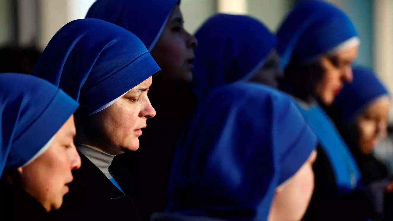 Nuns pray the Rosary in front of Gemelli Hospital, where Pope Francis is admitted for treatment, in Rome, Italy, February 22, 2025. Reuters/Vincenzo Livieri