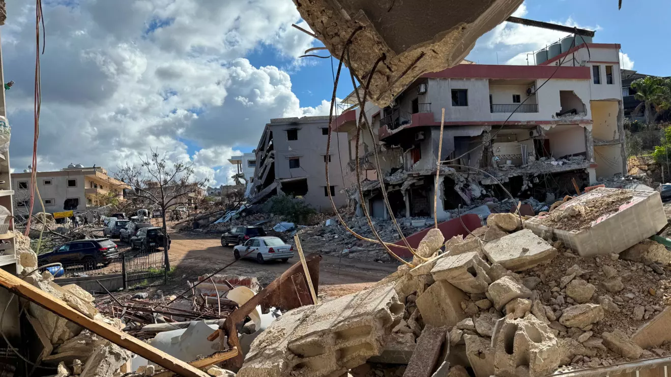 Cars drive past damaged buildings, as residents return to Naqoura, near the border with Israel, southern Lebanon, January 23, 2025. Reuters/Ali Hankir