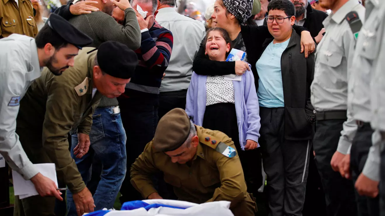 Mourners attend the funeral of Israeli soldier Captain Oshri Moshe Butzhak, who was killed in the Gaza Strip during the Israeli army's ongoing ground operation amid the conflict with Palestinian Islamist group Hamas, at a cemetery in Haifa, Israel, December 24, 2023. Reuters/Shir Torem