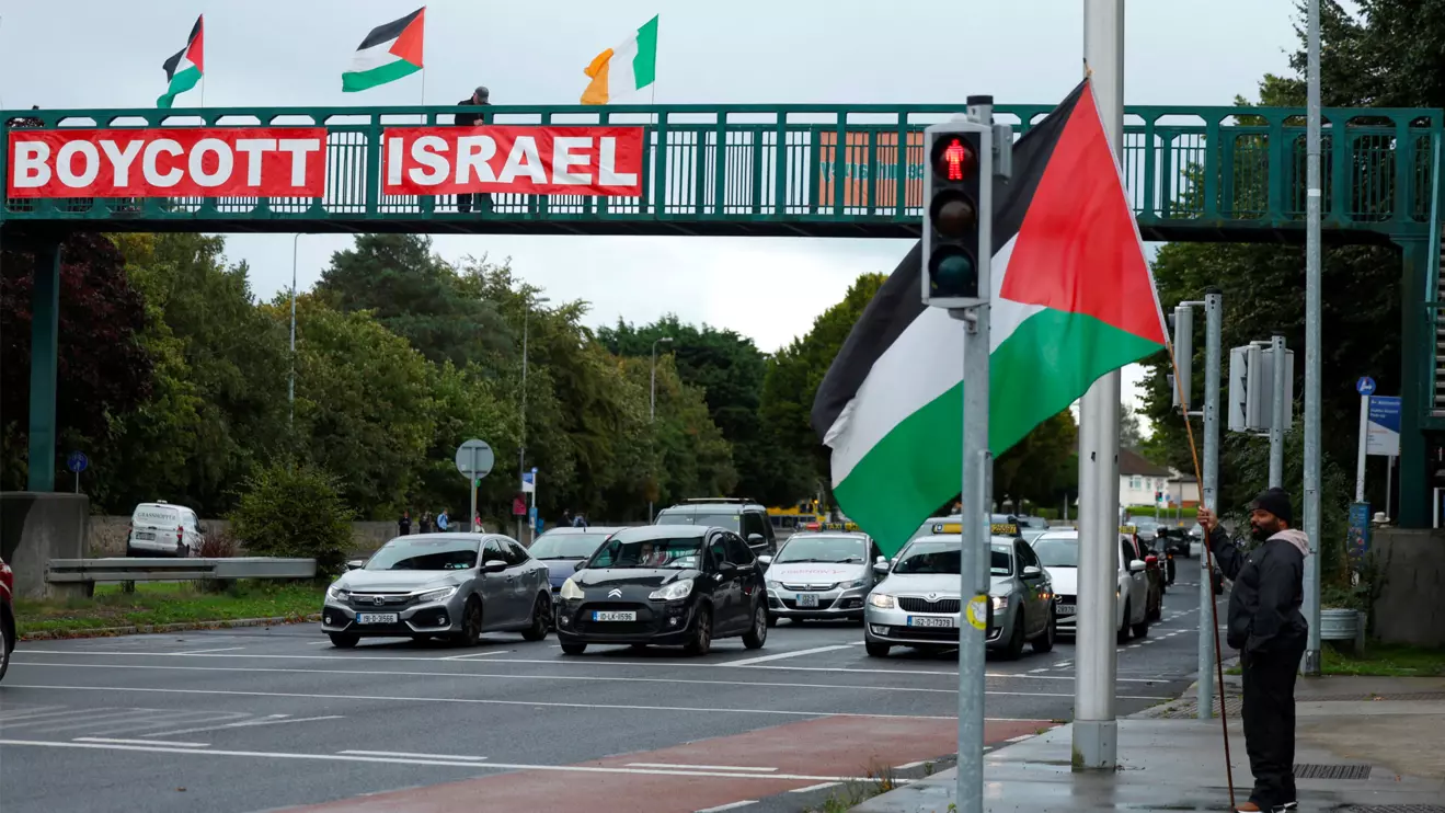 Pro-Palestinian protestors hold flags and a sign on a motorway overpass outside the RTE (Radio Telefis Eireann) Irish public service broadcaster television studios, in Dublin, Ireland, September 11, 2025. Reuters/Clodagh Kilcoyne