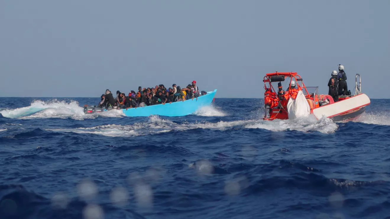 Migrants aboard an overcrowded boat are approached by the crew of the migrant search and rescue ship Sea-Watch 5, operated by the German NGO Sea-Watch, during a rescue operation in the Search and Rescue (SAR) zone in the central Mediterranean, off Libya, August 11, 2025. Reuters/Louisa Gouliamaki