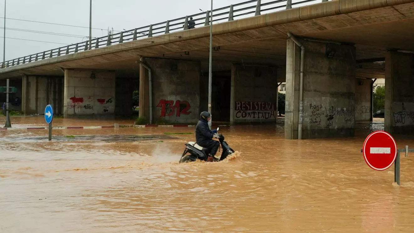 A person rides a motorcycle through a flooded street as torrential rains hit the country, in Tunis, Tunisia January 20, 2026. Reuters/Jihed Abidellaoui