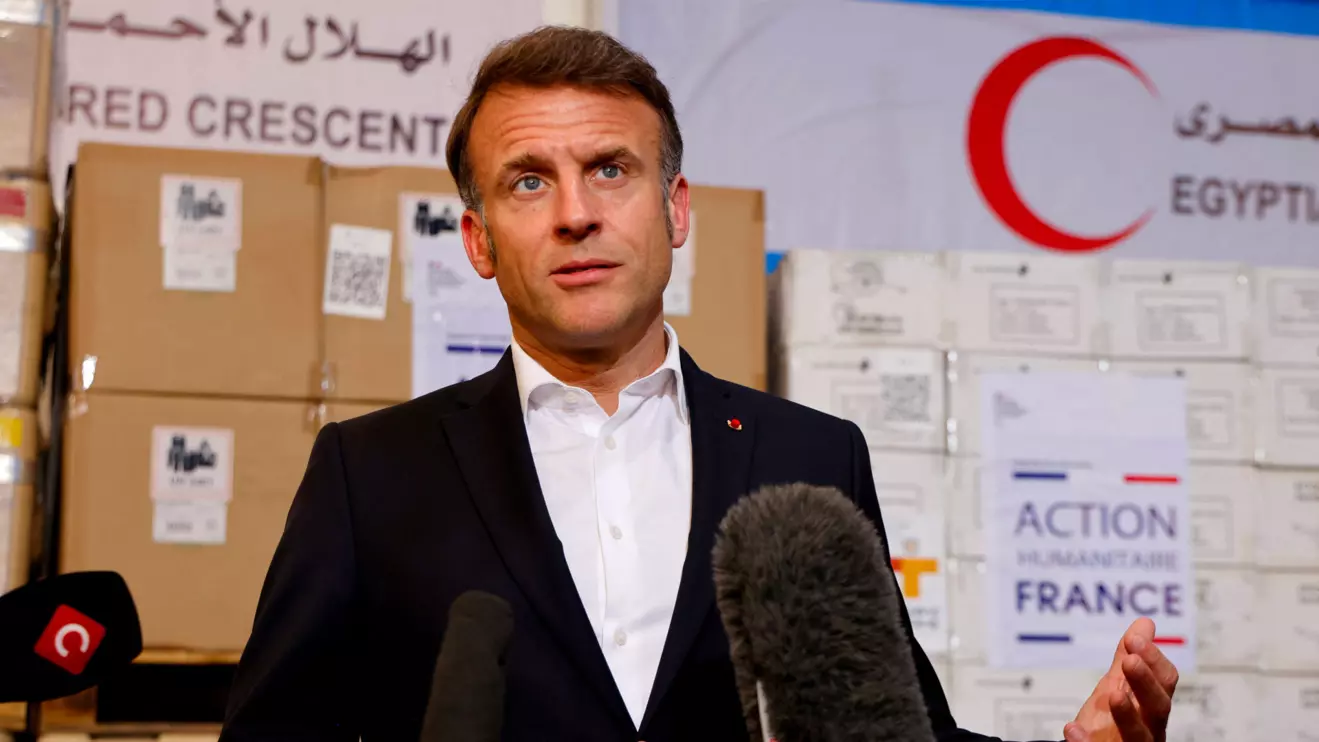 France's President Emmanuel Macron speaks in front of humanitarian aid destined to Gaza, at the Egyptian Red Crescent warehouse in Arish, Egypt April 8, 2025. Ludovic Marin/Reuters