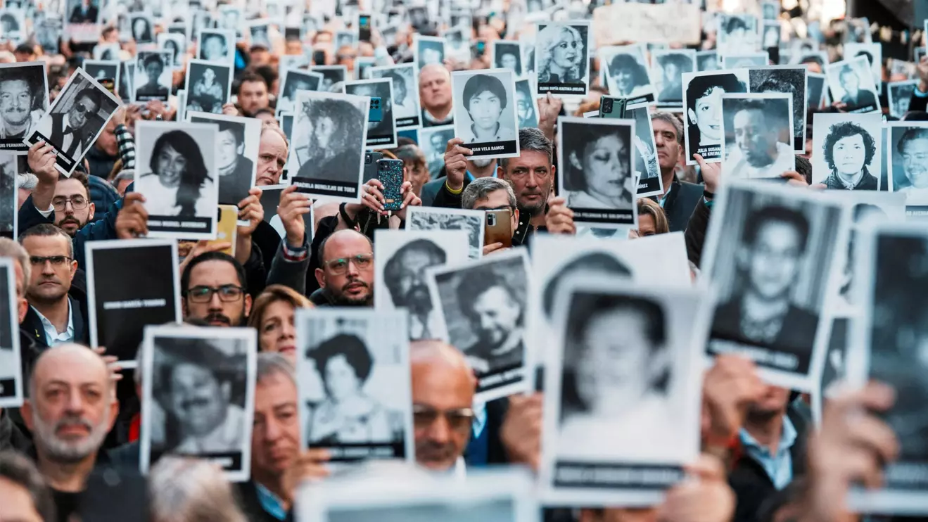 People hold images of the victims of the 1994 bombing attack on the Argentine Israeli Mutual Association (AMIA) community centre, marking the 30th anniversary of the attack, in Buenos Aires, Argentina July 18, 2024. Reuters/Irina Dambrauskas