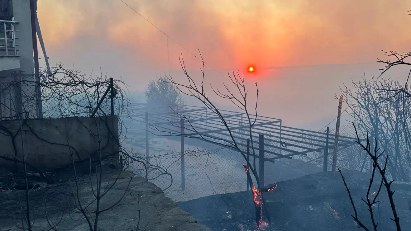 A house is damaged by fire, as a wildfire burns in Erenkoy in the northwestern Canakkale province, Turkey, August 11, 2025. Kanal17haber