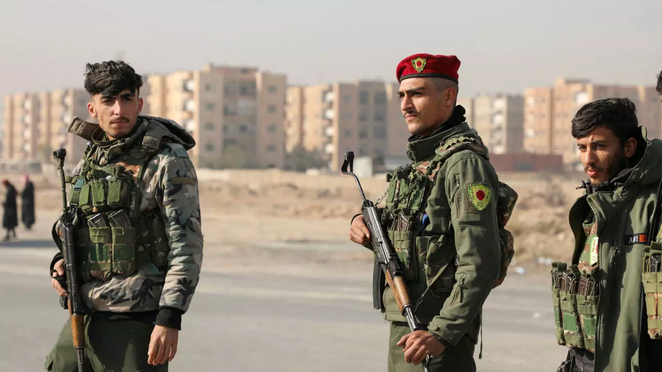 Members of Kurdish-led Syrian Democratic Forces (SDF) stand along a street, after rebels seized the capital and ousted Syria's Bashar al-Assad, in Hasakah, Syria December 11, 2024. Reuters/Orhan Qereman
