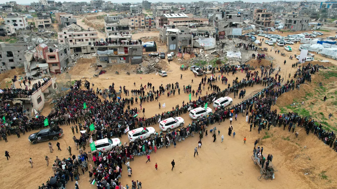 A drone view shows Palestinians and militants gathering around Red Cross vehicles on the day Hamas hands over the bodies of deceased hostages Oded Lifschitz, Shiri Bibas and her two children Kfir and Ariel Bibas, seized during the deadly October 7, 2023 attack, as part of a ceasefire and hostages-prisoners swap deal between Hamas and Israel, in Khan Younis in the southern Gaza Strip, February 20, 2025. Reuters