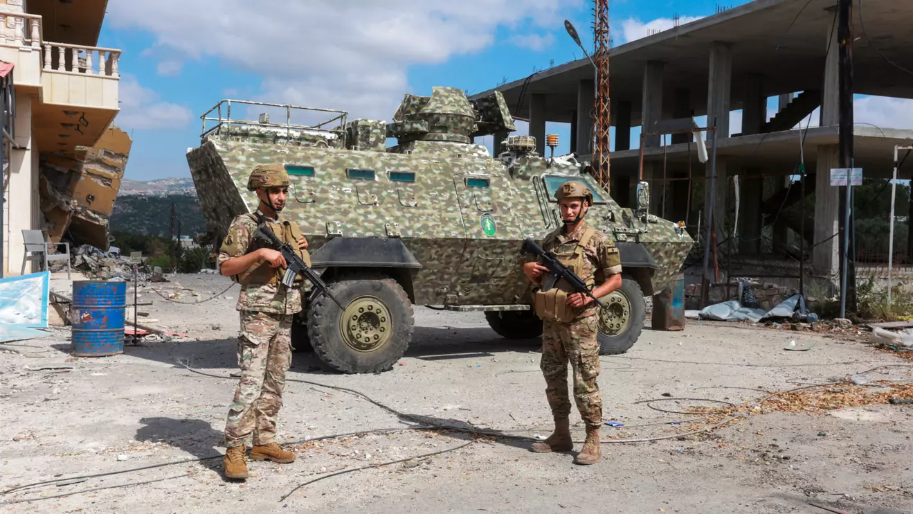 Members of the Lebanese army stand guard next to an armoured personnel carrier. Reuters/Aziz Taher