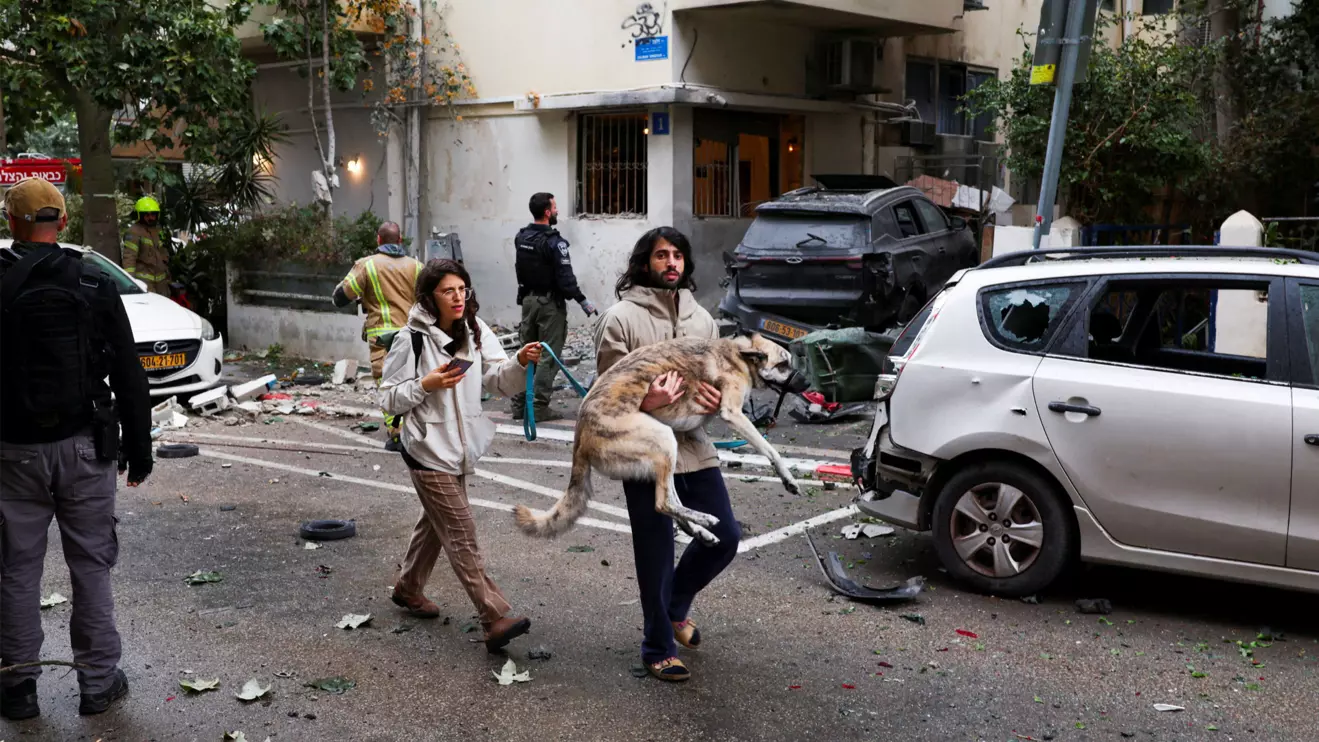 A man carries a dog to a shelter as sirens sound after Iran launched missiles towards Israel, amid the U.S.-Israel conflict with Iran, in Tel Aviv, Israel, April 1, 2026. Reuters/Ronen Zvulun