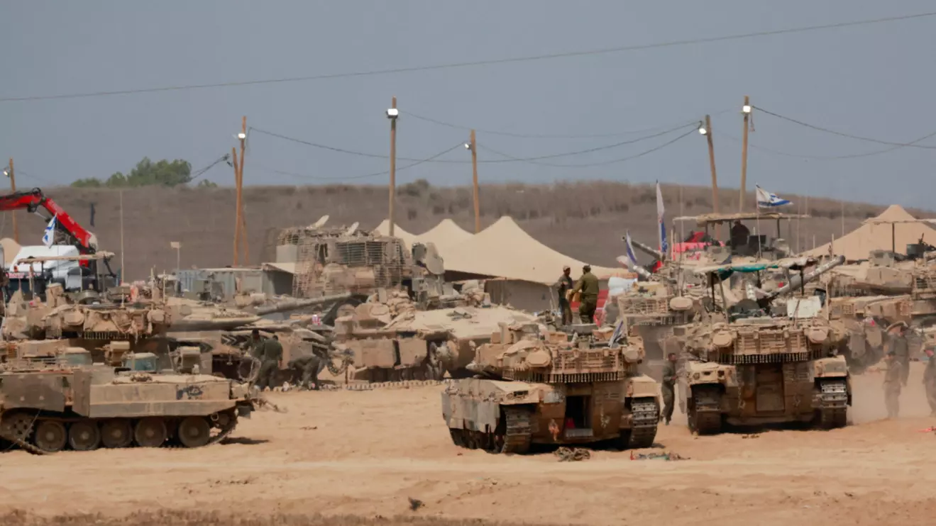 A view shows military vehicles on the Israeli side of the border with Gaza, as seen from Israel, August 12, 2025. Reuters/Ammar Awad