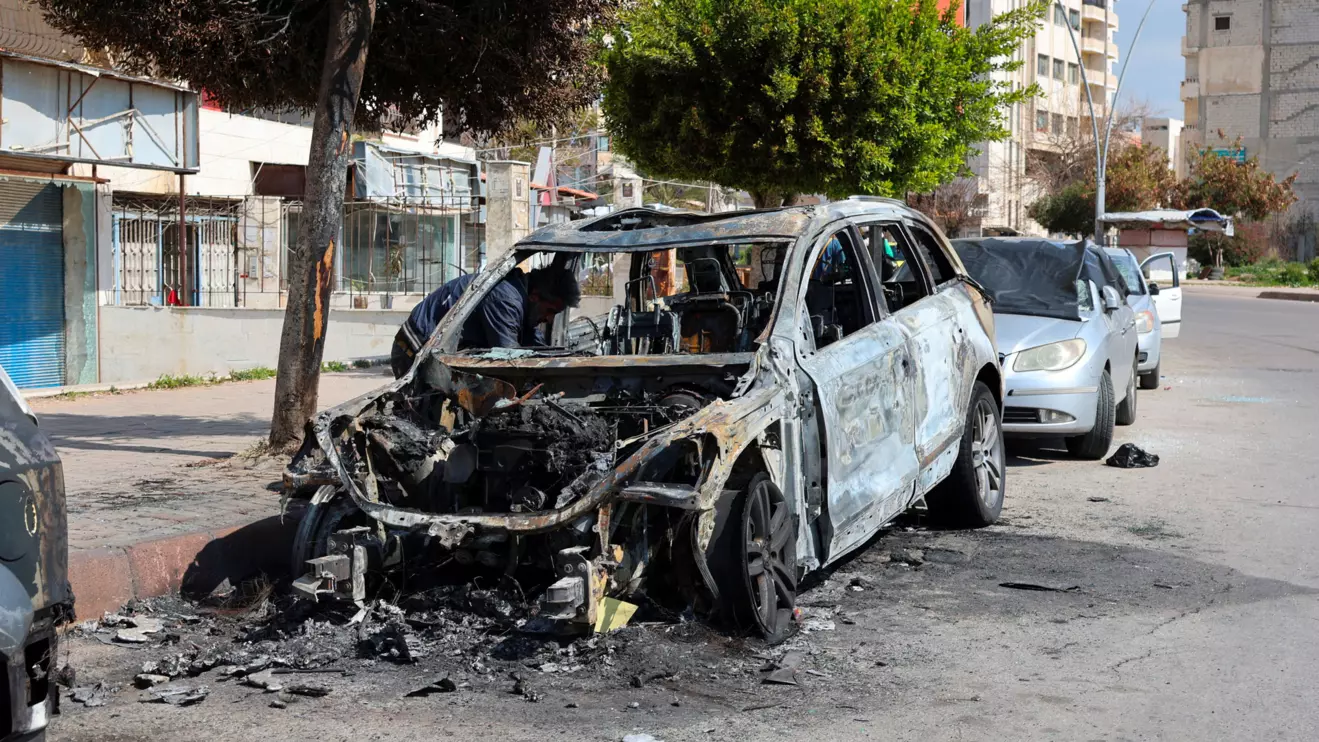 A man inspects a damaged car in Latakia, after hundreds were reportedly killed in some of the deadliest violence in 13 years of civil war, pitting loyalists of deposed President Bashar al-Assad against the country's new Islamist rulers, Syria March 9, 2025. Reuters/Haidar Mustafa