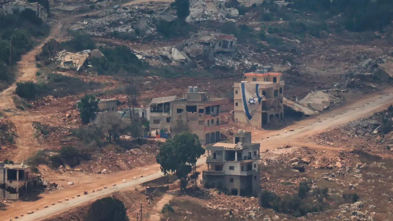 An Israeli flag hangs from a building in Lebanon as seen from the Israeli side of the Israel-Lebanon border, in northern Israel, July 5, 2026. Reuters/Shir Torem