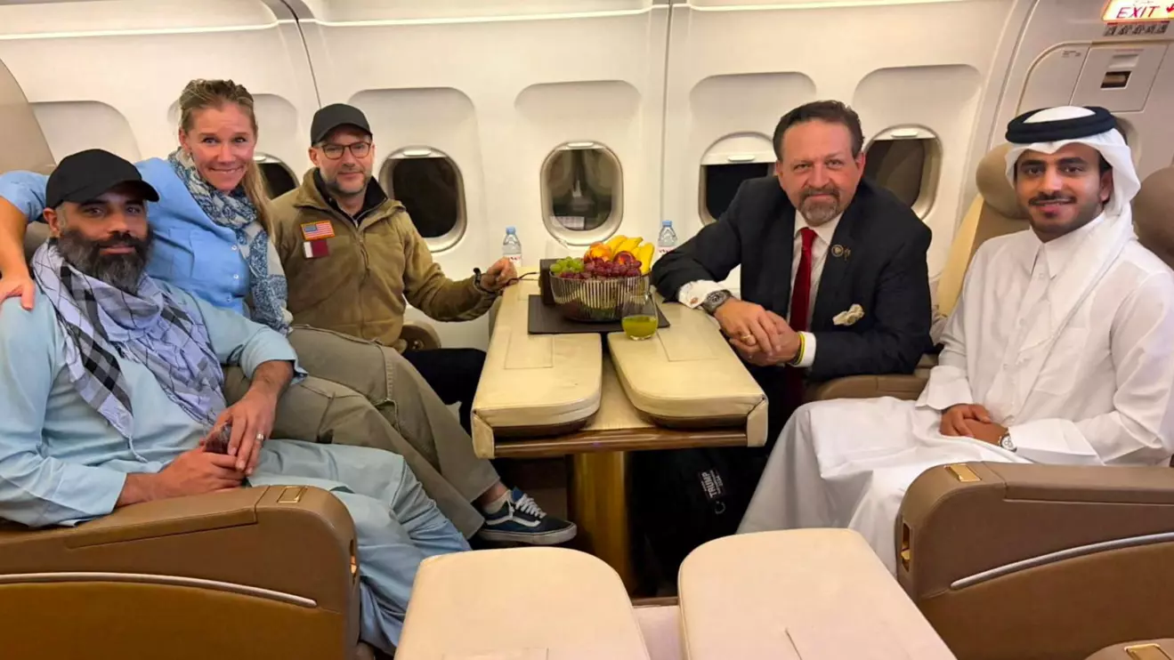 Amir Amiri, who had been detained in Afghanistan since December 2024, poses for a picture alongside Adam Boehler, the U.S. special envoy for hostage response, Sebastian Gorka, the deputy assistant to the U.S. president and senior director for counterterrorism, and a Qatari diplomat, on a plane from Kabul Afghanistan, September 28, 2025. Qatari Diplomat