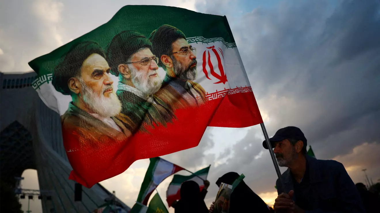 A man holds a flag during a rally in Tehran, Majid Asgaripour/WANA/Reuters