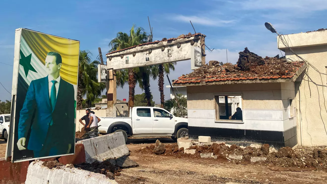 A poster depicting Syria's President Bashar al-Assad is seen at a damaged area in the aftermath of what Syrian state media reported was an Israeli strike in Hama, Syria September 9, 2024. Reuters/Firas Makdesi