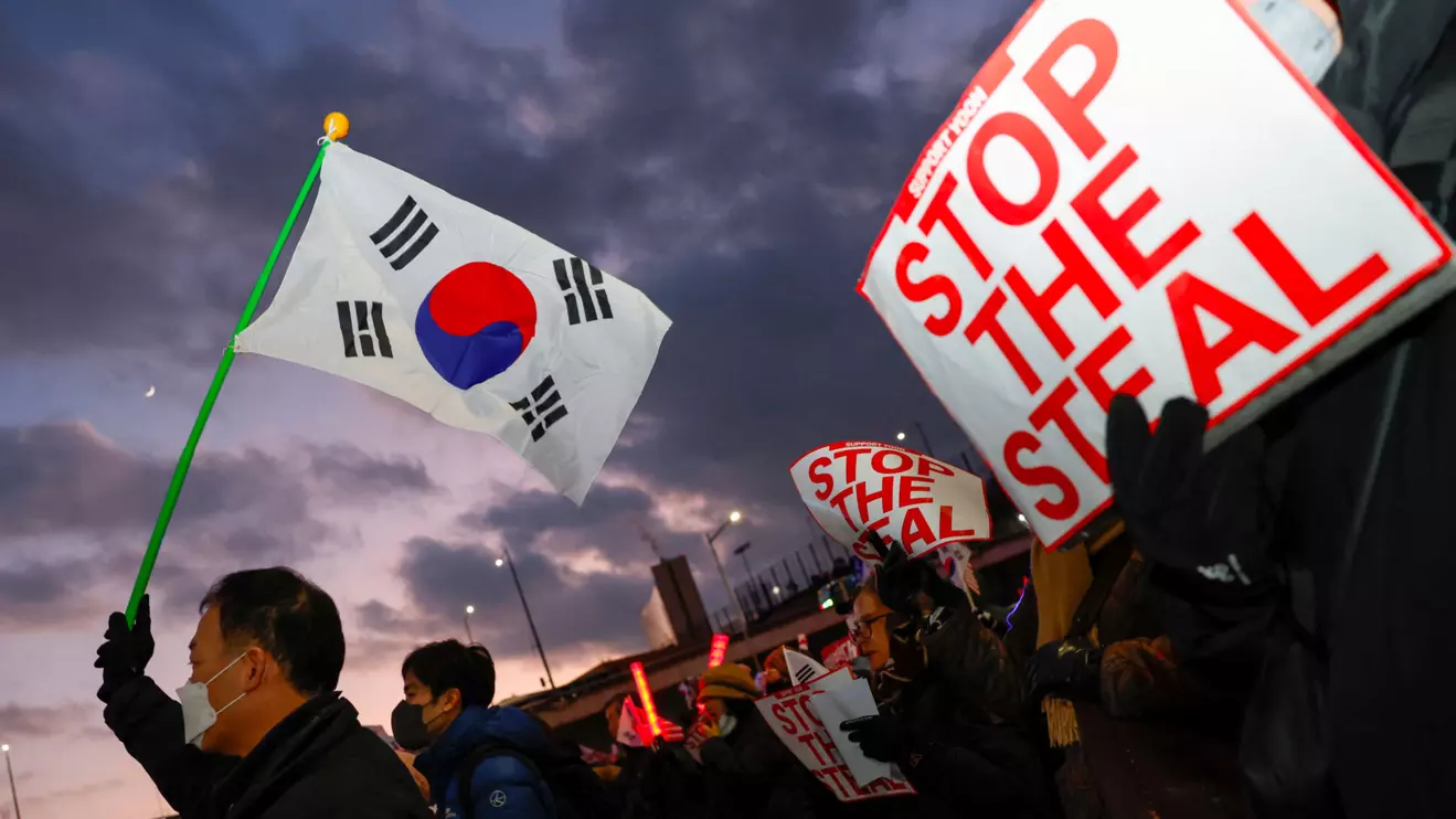Pro-Yoon protesters hold South Korean flags and 'STOP THE STEAL' signs during a rally near impeached South Korean President Yoon Suk Yeol's official residence, after investigators were unable to execute an arrest warrant on Friday for Yeol, according to the Corruption Investigation Office for High-ranking Officials, in Seoul, South Korea, January 3, 2025. Reuters/Kim Soo-hyeon