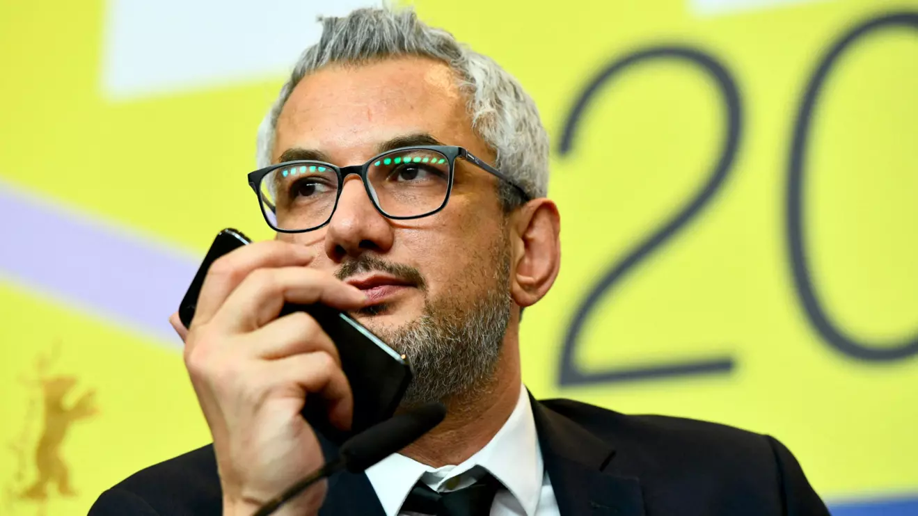 Director Mohammad Rasoulof, winner of the Golden Bear for Best Film for "There Is No Evil", speaks through a video call as producer Farzad Pak holds a cellphone, during a news conference after the award ceremony of the 70th Berlinale International Film Festival in Berlin, Germany February 29, 2020. Reuters/Annegret Hilse