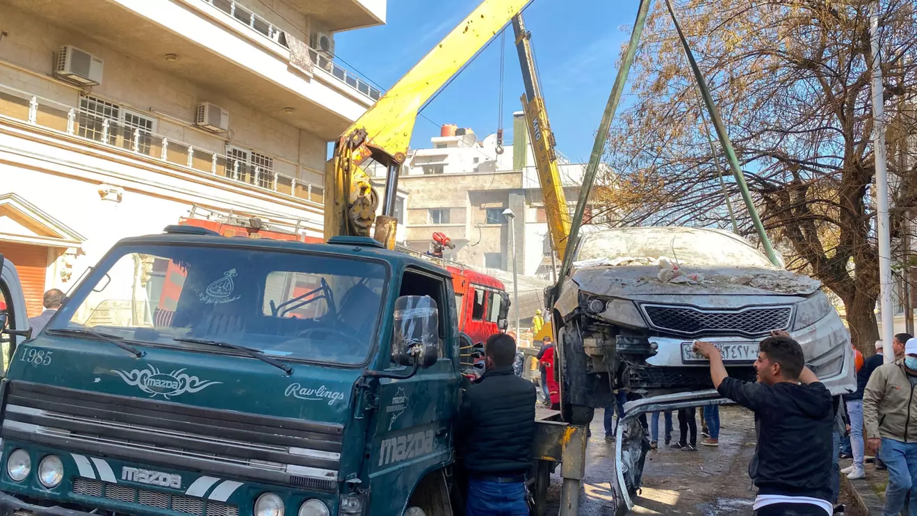 A crane lifts a damaged car near a site that was hit by an Israeli strike according to sources, in the Mazzeh neighborhood of Damascus, Reuters/Firas Makdesi