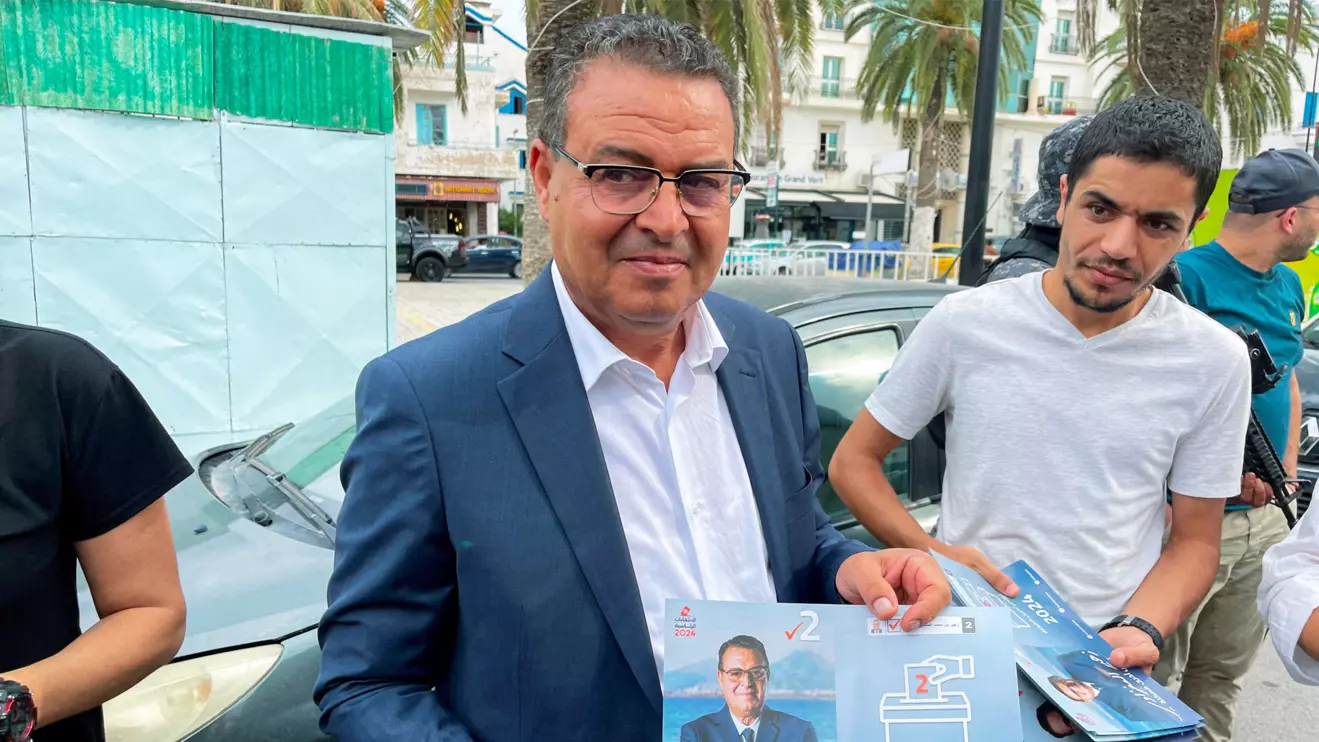 Zouhair Maghzaoui, presidential candidate and the Secretary-General of the Tunisian People's Movement party, holds his election campaign flyer as he meets with residents during his campaign in Tunis, Tunisia September 18, 2024. Reuters/Jihed Abidellaoui